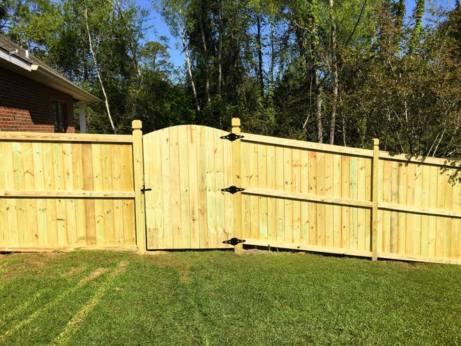 A new cedar privacy fence with a wide double gate, built by Dunnaway Fence